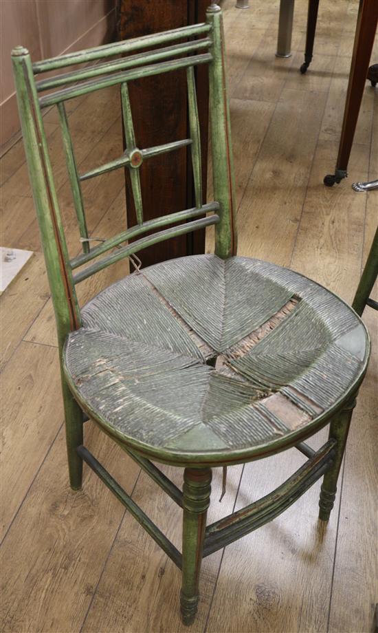 A set of five Regency style green painted salon chairs, with rush seats